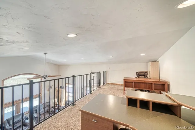 a kitchen with kitchen island a stove a chimney a sink and a counter top space