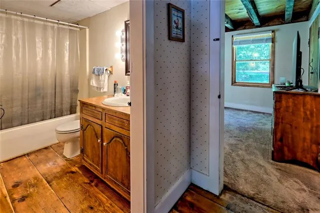 a view of a bathroom with bathtub and shower