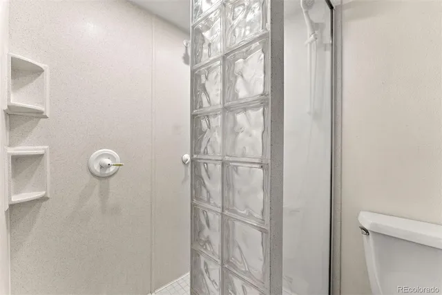 a bathroom with a glass shower door
