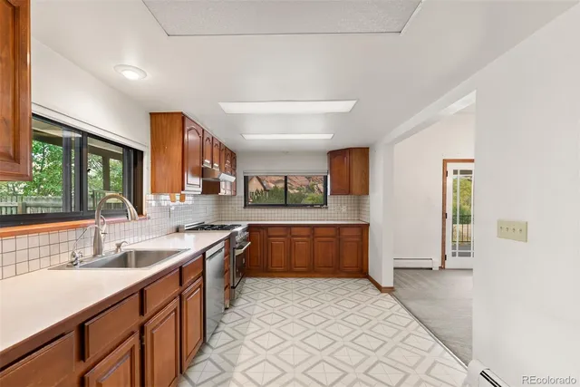 a kitchen with stainless steel appliances granite countertop a sink and cabinets