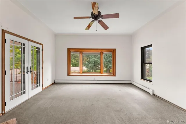 a view of room with window and ceiling fan