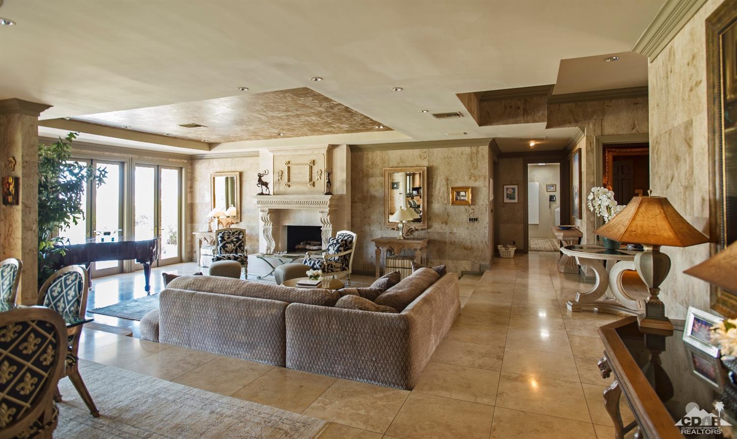 70375 Thunderbird Road Rancho Mirage, CA 92270 - Photo 12 of 54 a living room with furniture a fireplace and a chandelier