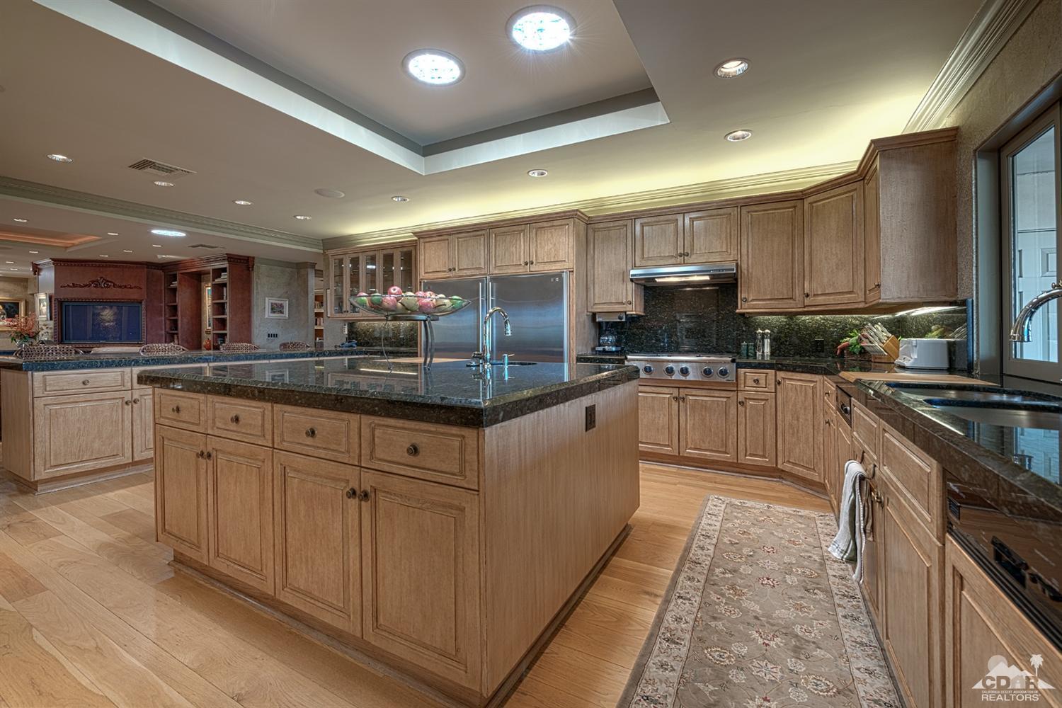 70375 Thunderbird Road Rancho Mirage, CA 92270 - Photo 14 of 54 a kitchen with granite countertop a sink stainless steel appliances and cabinets