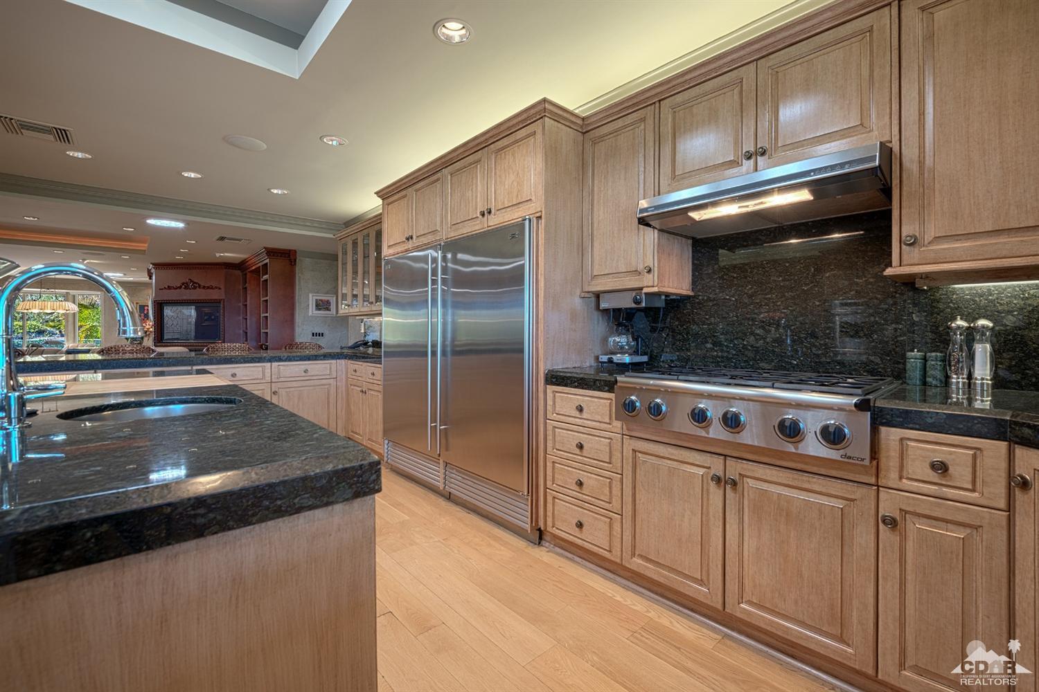 70375 Thunderbird Road Rancho Mirage, CA 92270 - Photo 15 of 54 a kitchen with stainless steel appliances granite countertop a stove a sink and a refrigerator