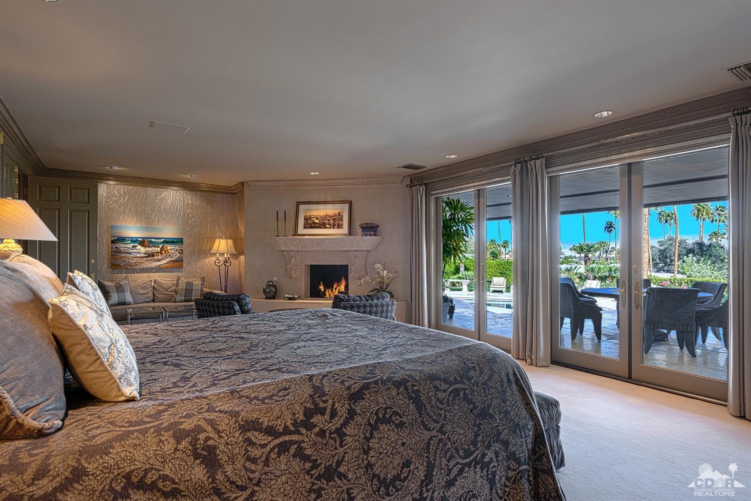 70375 Thunderbird Road Rancho Mirage, CA 92270 - Photo 21 of 54 a spacious bedroom with a large bed and a large window