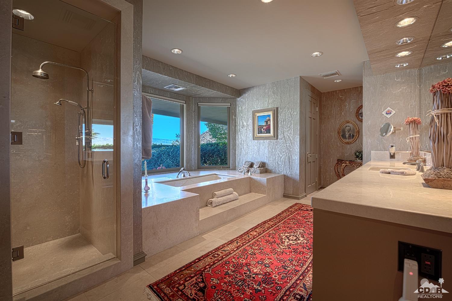 70375 Thunderbird Road Rancho Mirage, CA 92270 - Photo 25 of 54 a spacious bathroom with a sink a large mirror and a shower