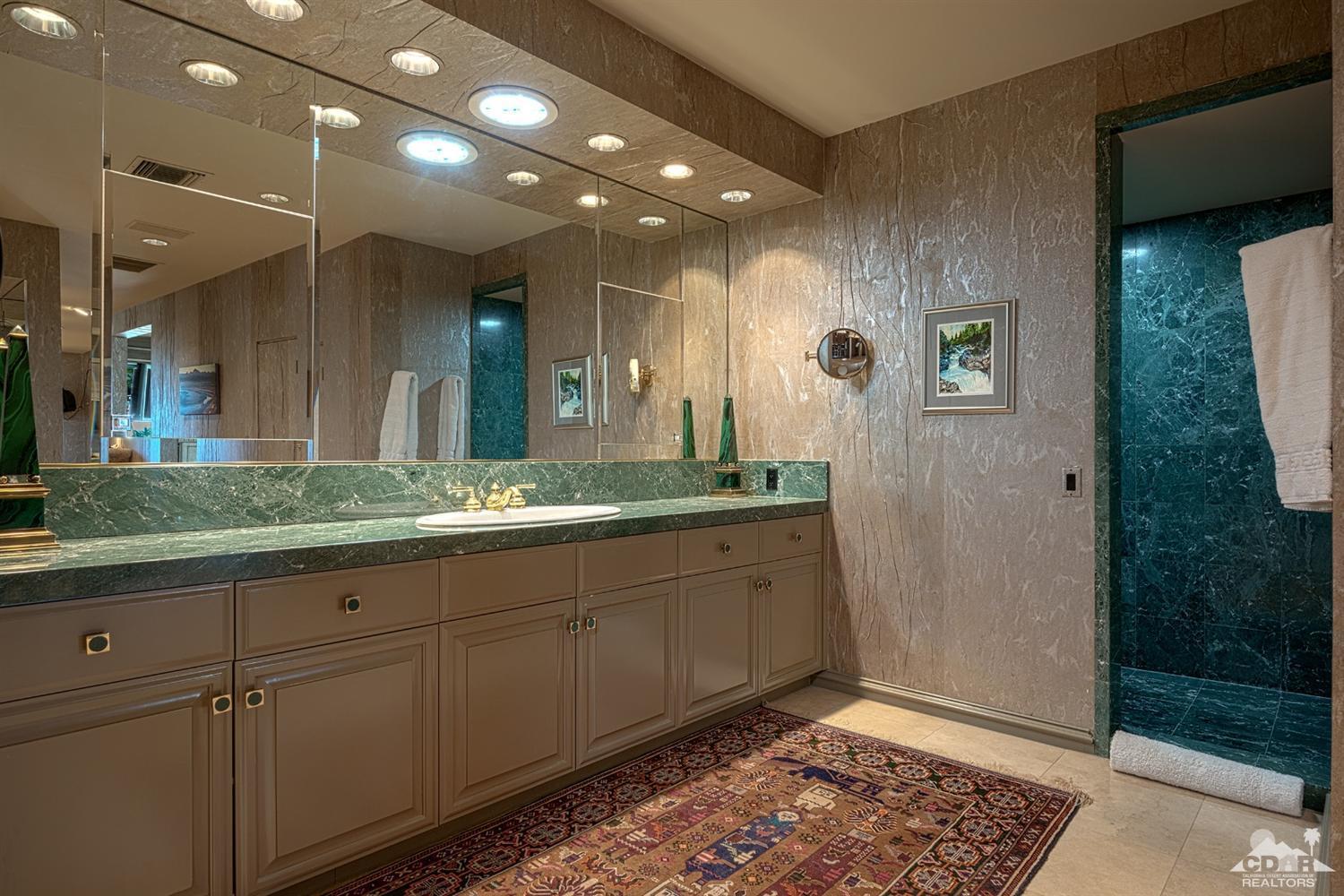 70375 Thunderbird Road Rancho Mirage, CA 92270 - Photo 27 of 54 a bathroom with a double vanity sink and a mirror