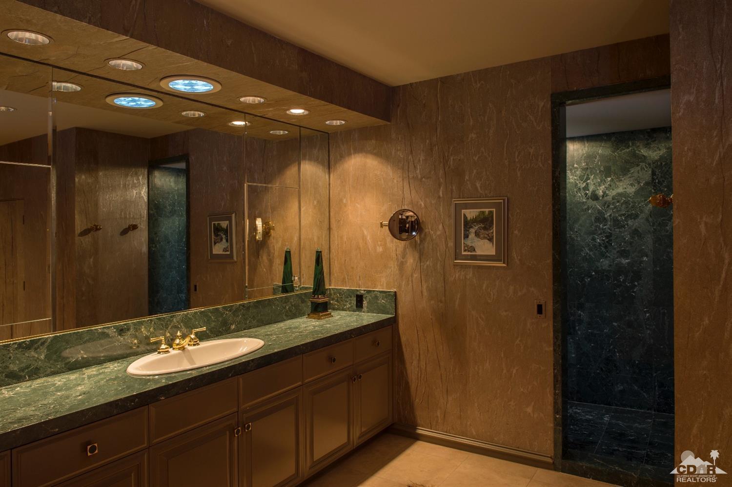 70375 Thunderbird Road Rancho Mirage, CA 92270 - Photo 28 of 54 a bathroom with a sink and a mirror