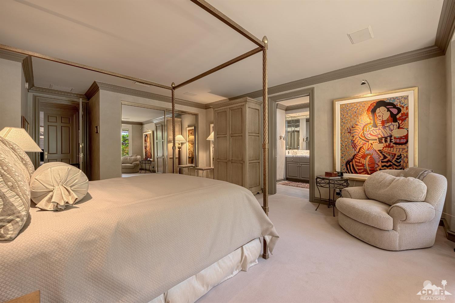 70375 Thunderbird Road Rancho Mirage, CA 92270 - Photo 30 of 54 a spacious bedroom with a bed and a couch