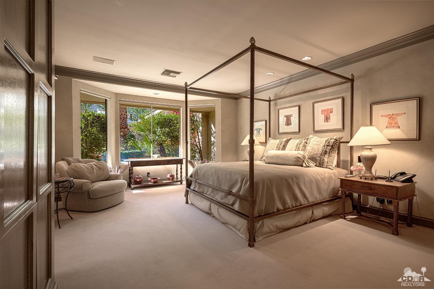 70375 Thunderbird Road Rancho Mirage, CA 92270 - Photo 31 of 54 a spacious bedroom with a bed and a couch