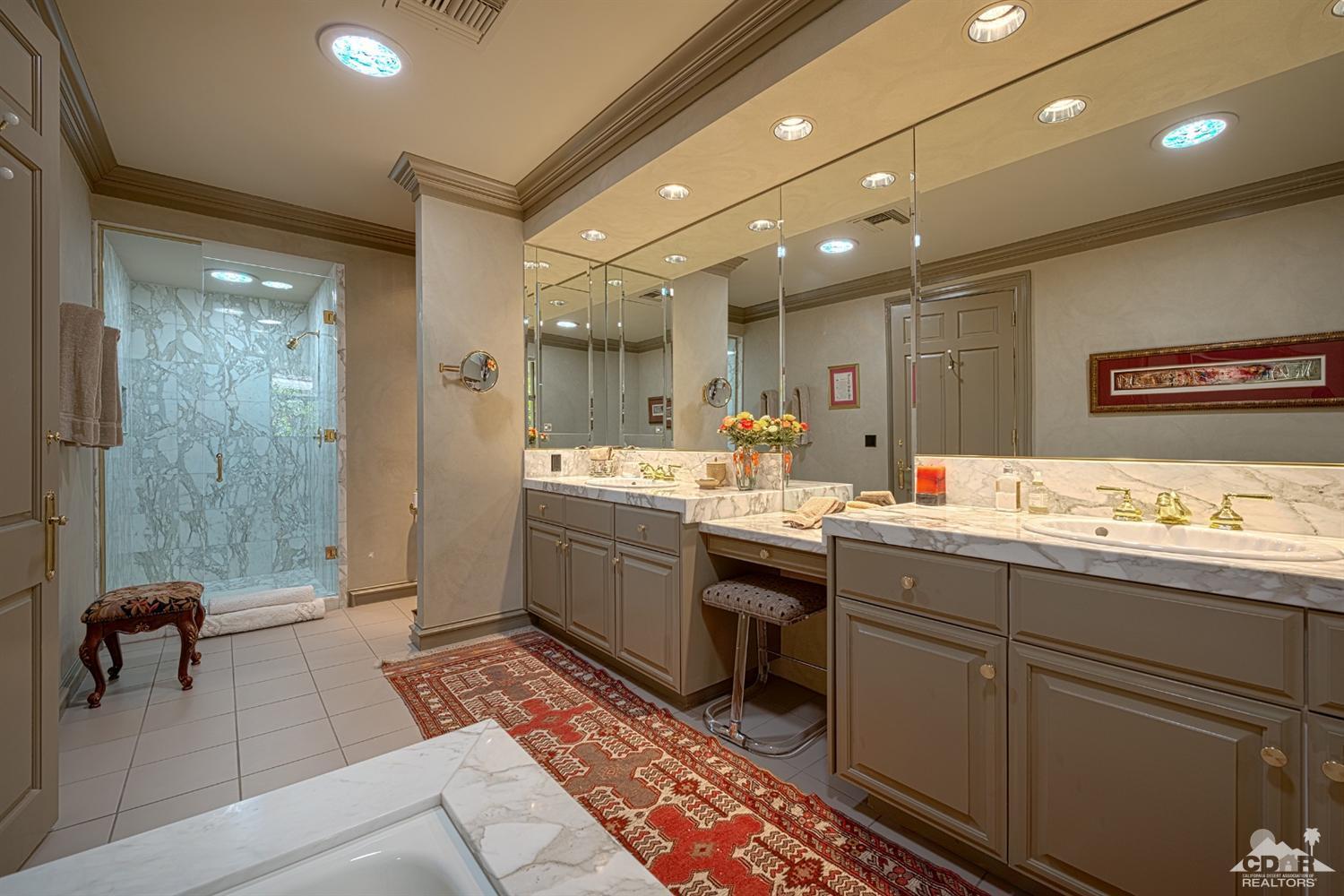70375 Thunderbird Road Rancho Mirage, CA 92270 - Photo 32 of 54 a bathroom with a double vanity sink a mirror and a bathtub