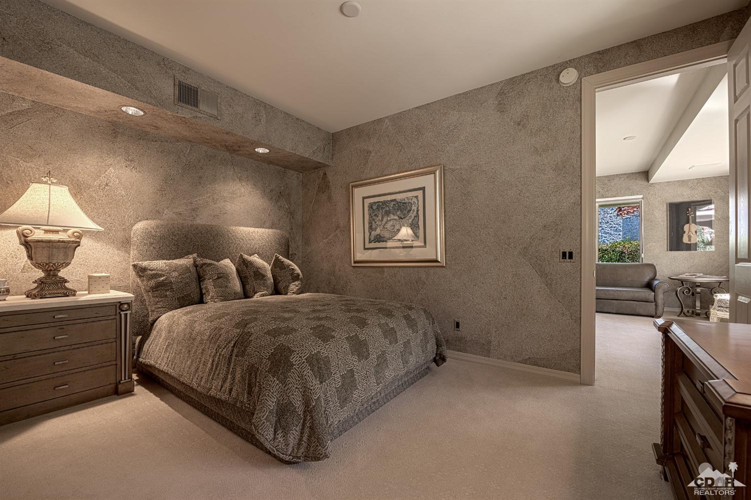 70375 Thunderbird Road Rancho Mirage, CA 92270 - Photo 39 of 54 a spacious bedroom with two beds and painting on the wall