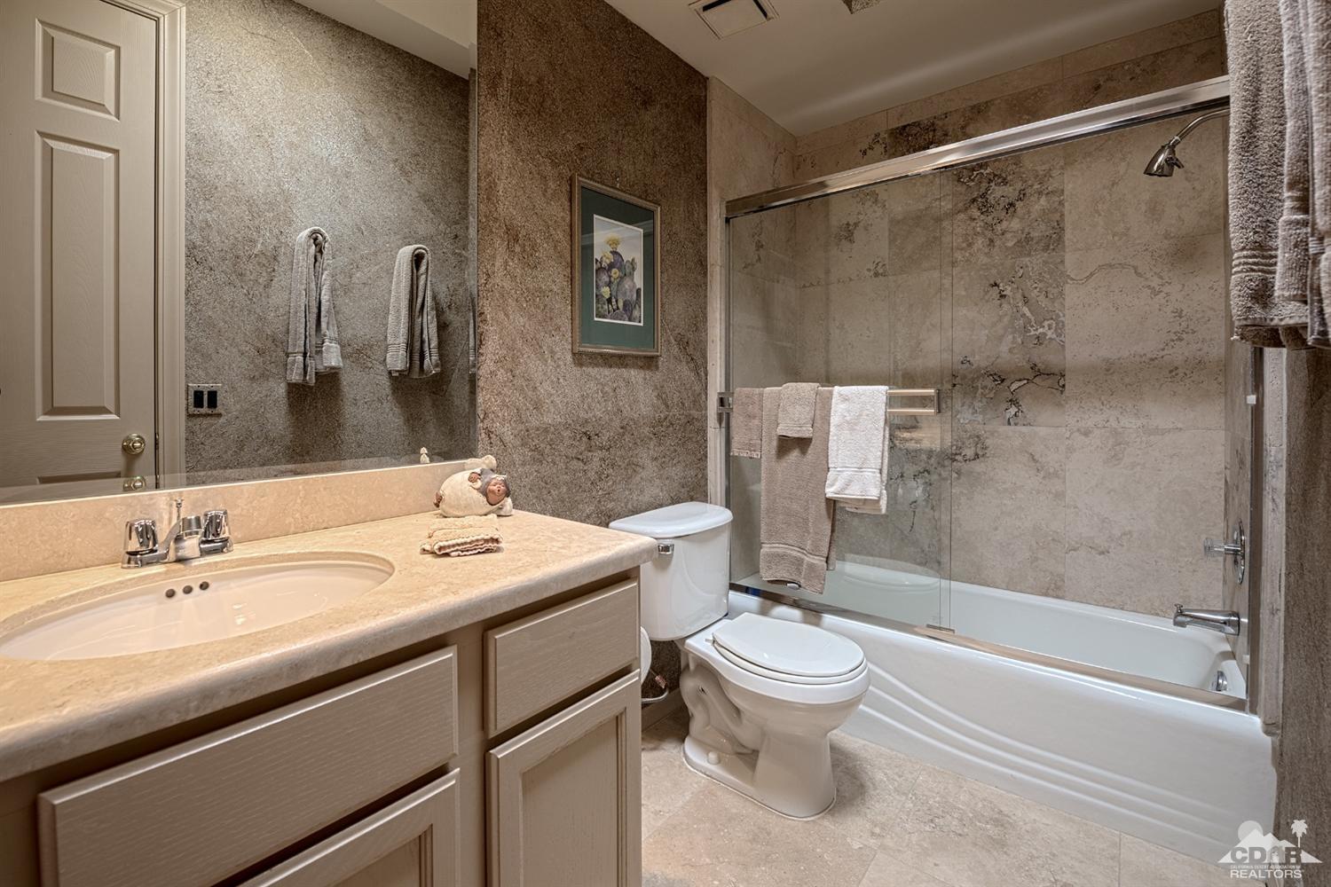 70375 Thunderbird Road Rancho Mirage, CA 92270 - Photo 40 of 54 a bathroom with a sink toilet and shower