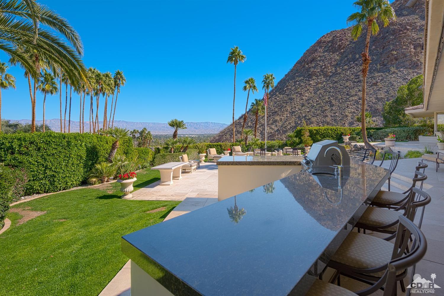 70375 Thunderbird Road Rancho Mirage, CA 92270 - Photo 43 of 54 a view of a swimming pool with a patio and a yard