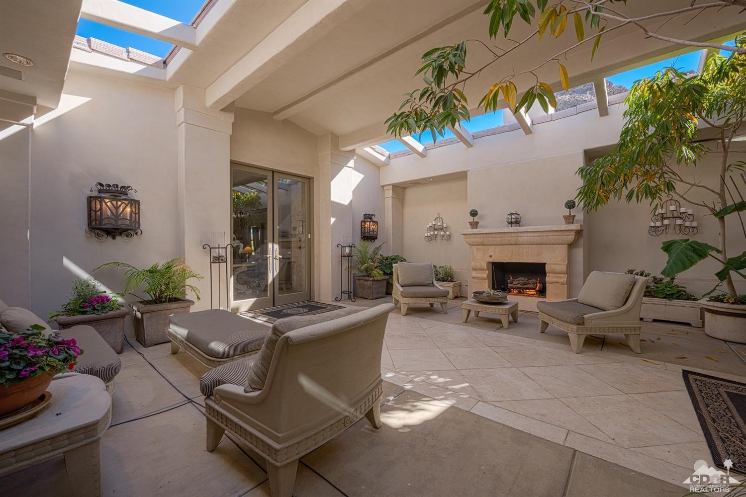 70375 Thunderbird Road Rancho Mirage, CA 92270 - Photo 8 of 54 a living room with furniture a fireplace and a potted plant