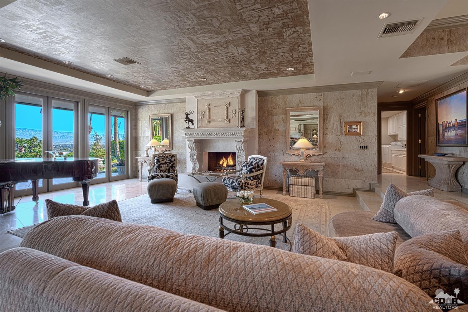 70375 Thunderbird Road Rancho Mirage, CA 92270 - Photo 10 of 54 a living room with furniture fireplace and a large window