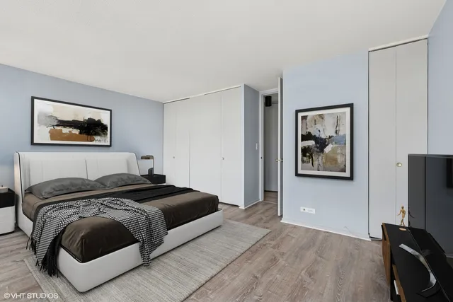 a bedroom with a bed and painting on the wall