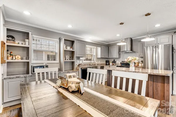 a kitchen with counter space dining table and chairs