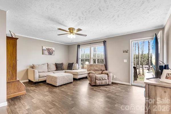 a spacious bedroom with a bed and a flat screen tv