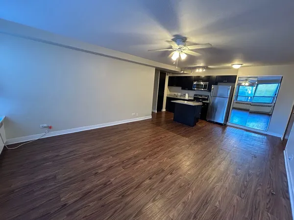 a view of a livingroom with furniture wooden floor and chandelier
