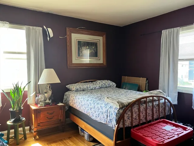 a bedroom with a bed and a lamp