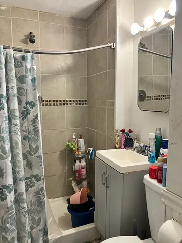 a bathroom with a sink toilet and shower