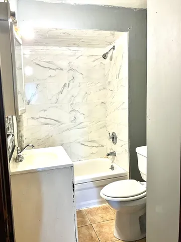 a bathroom with a toilet and a shower curtain
