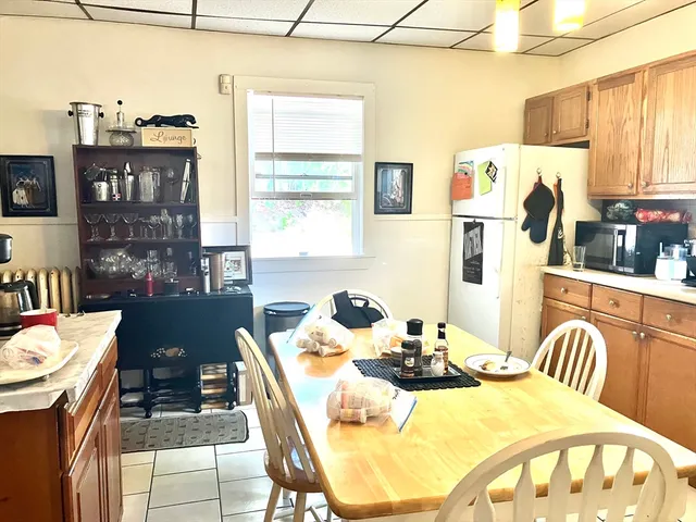 a view of a dining room with furniture and chandelier