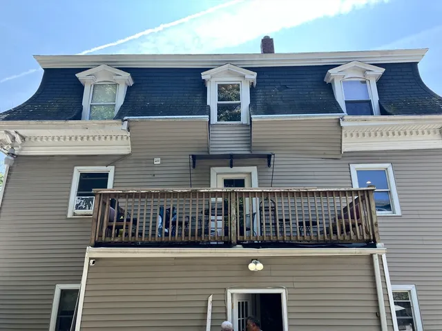 a front view of a house with many windows