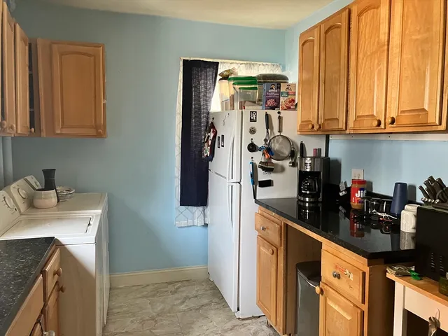 a kitchen with stainless steel appliances granite countertop a refrigerator and a sink