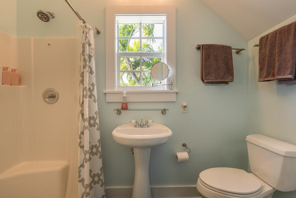 525 Louisa Street Key West, FL 33040 - Photo 25 of 43 a bathroom with a sink toilet and a mirror