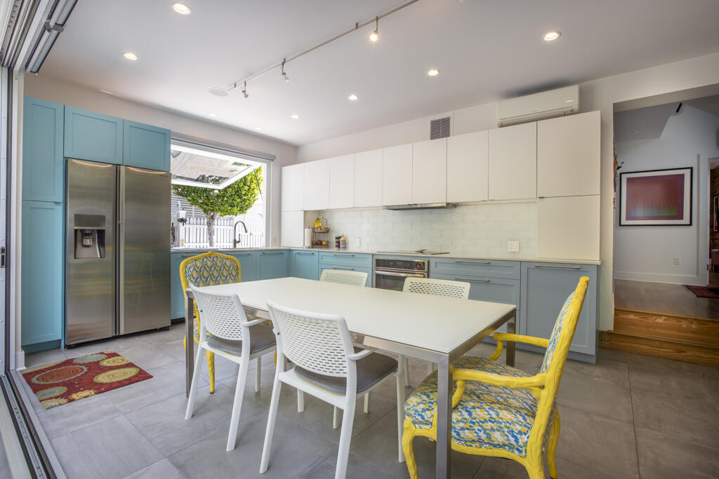 525 Louisa Street Key West, FL 33040 - Photo 8 of 43 a view of kitchen with stainless steel appliances granite countertop dining table and chairs