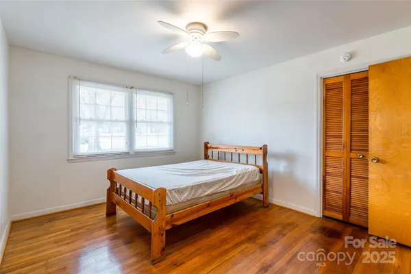 a bedroom with a bed and a table