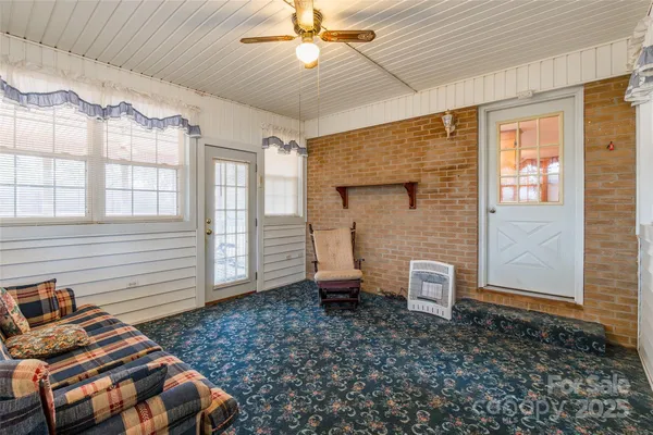 a view of a porch with a table and chairs