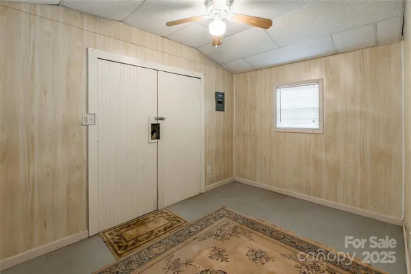 a view of a room with wooden floor and a window