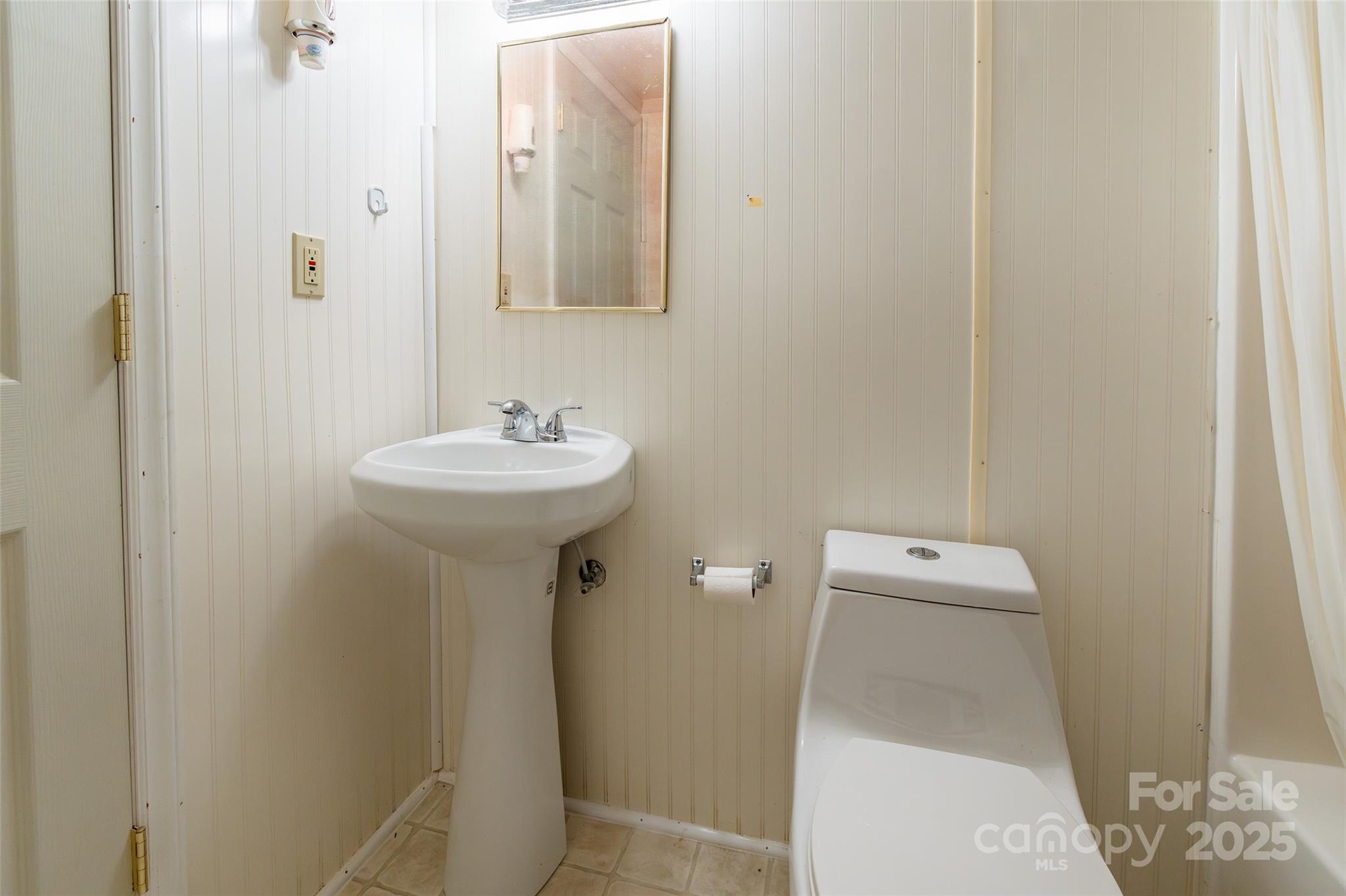 2100 J B Denton Road Lancaster, SC 29720 - Photo 40 of 44 a bathroom with a sink mirror and toilet