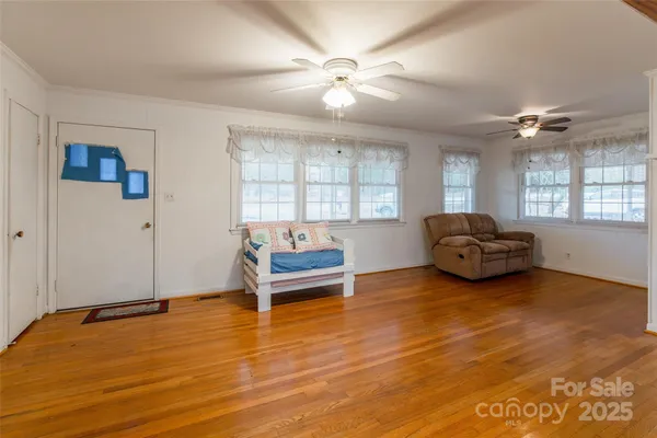 a view of a room with wooden floor and window