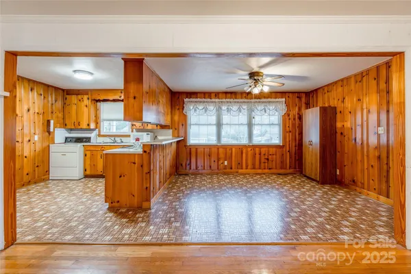 a view of a room with a window and a ceiling fan