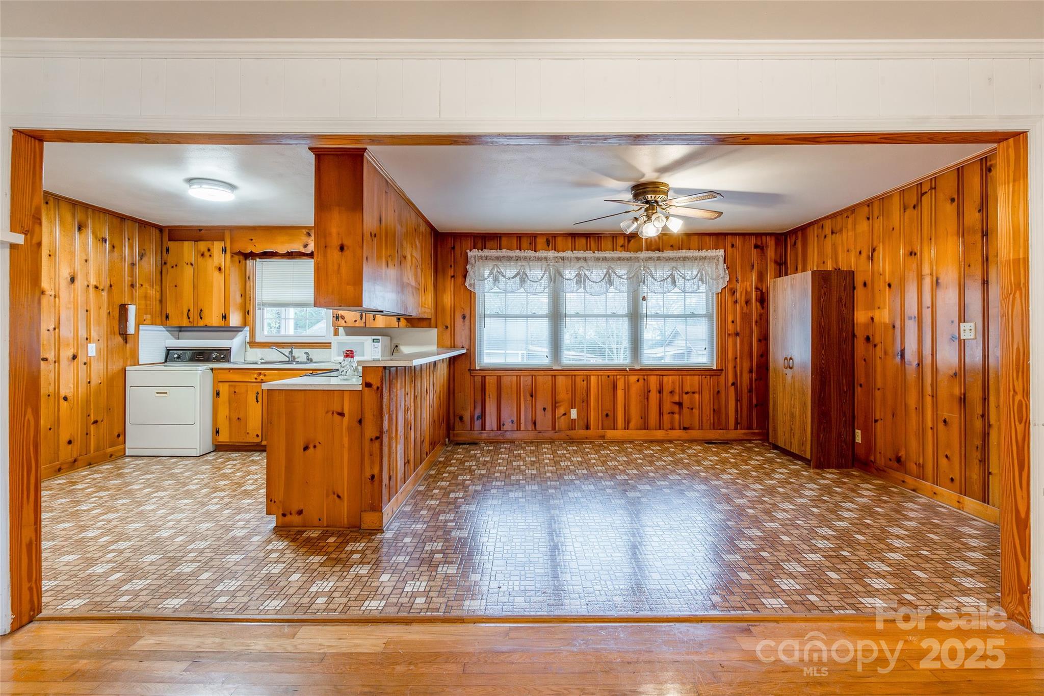 2100 J B Denton Road Lancaster, SC 29720 - Photo 8 of 44 a kitchen with stainless steel appliances granite countertop a refrigerator a sink dishwasher a stove and a dining table with wooden floor