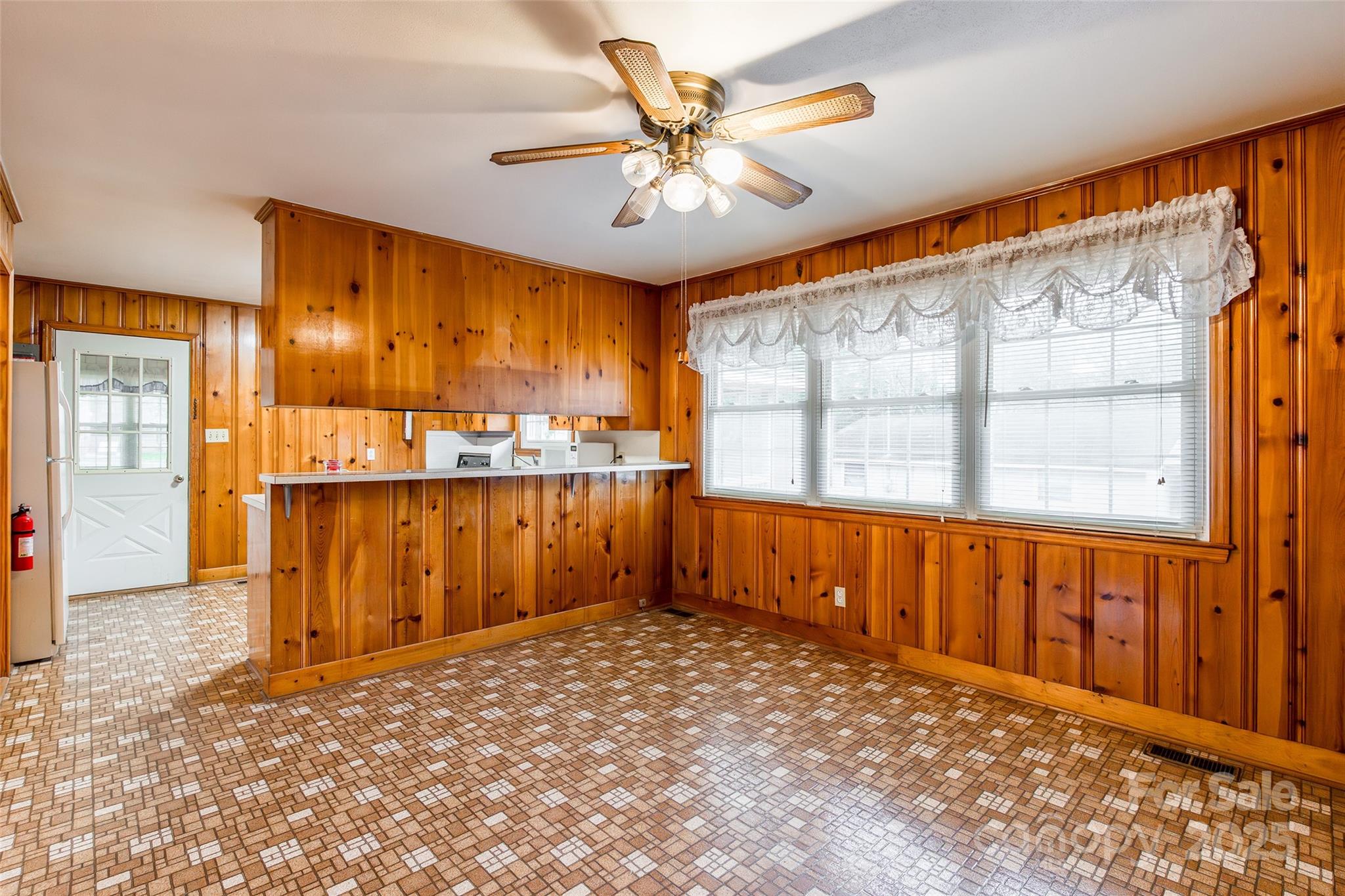 2100 J B Denton Road Lancaster, SC 29720 - Photo 10 of 44 an empty room with chandelier fan and windows
