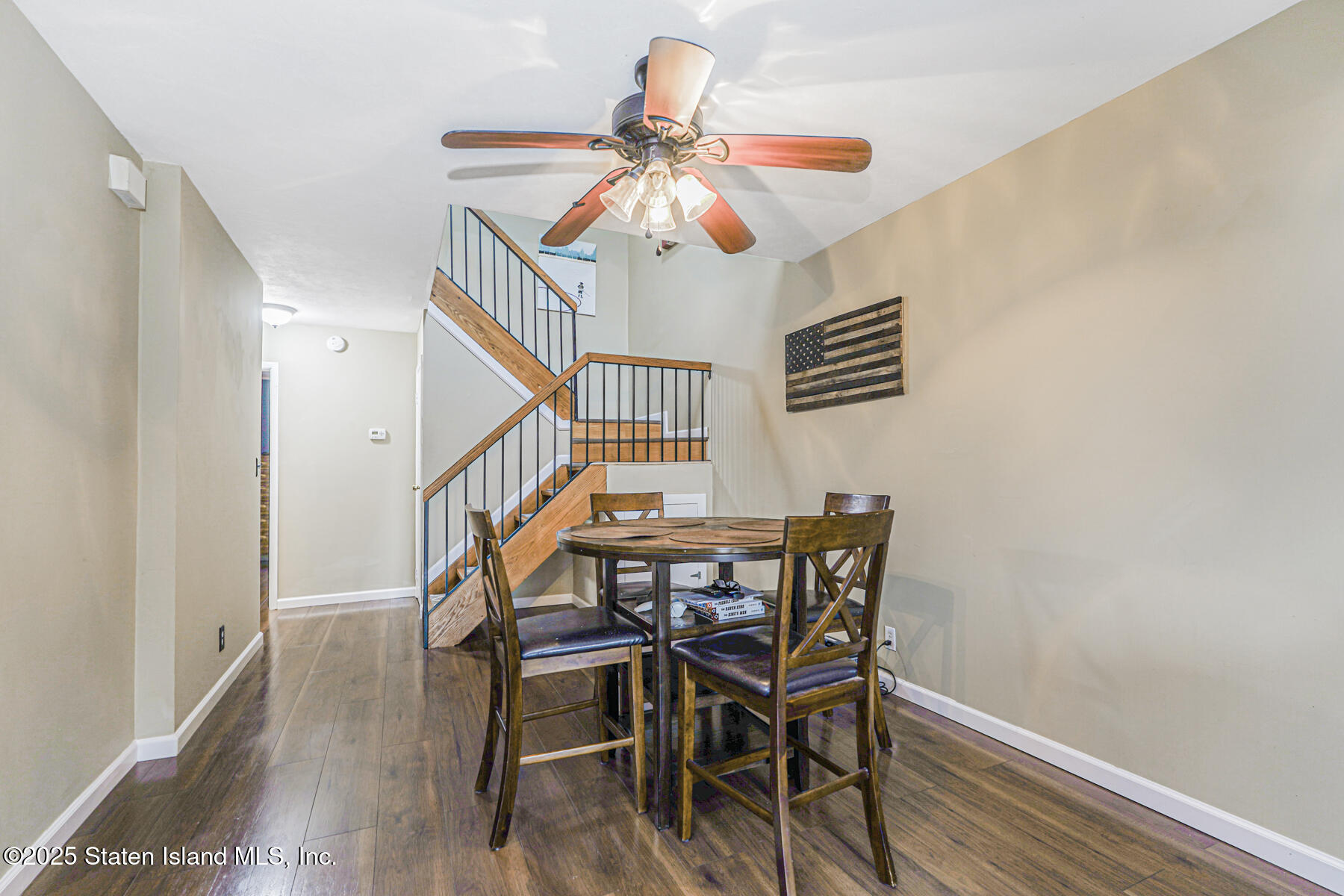 272 Timber Ridge Drive Staten Island, NY 10306 - Photo 6 of 26 a dining room with wooden floor a chandelier a wooden table and chairs