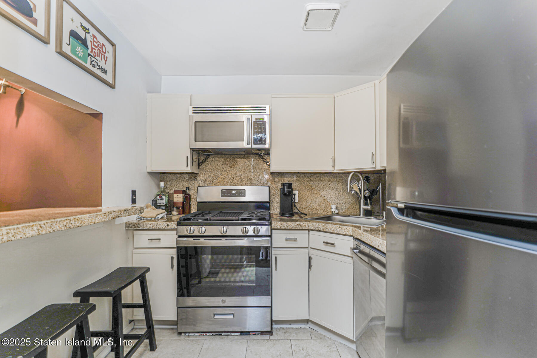 272 Timber Ridge Drive Staten Island, NY 10306 - Photo 10 of 26 a kitchen with a stove and a sink