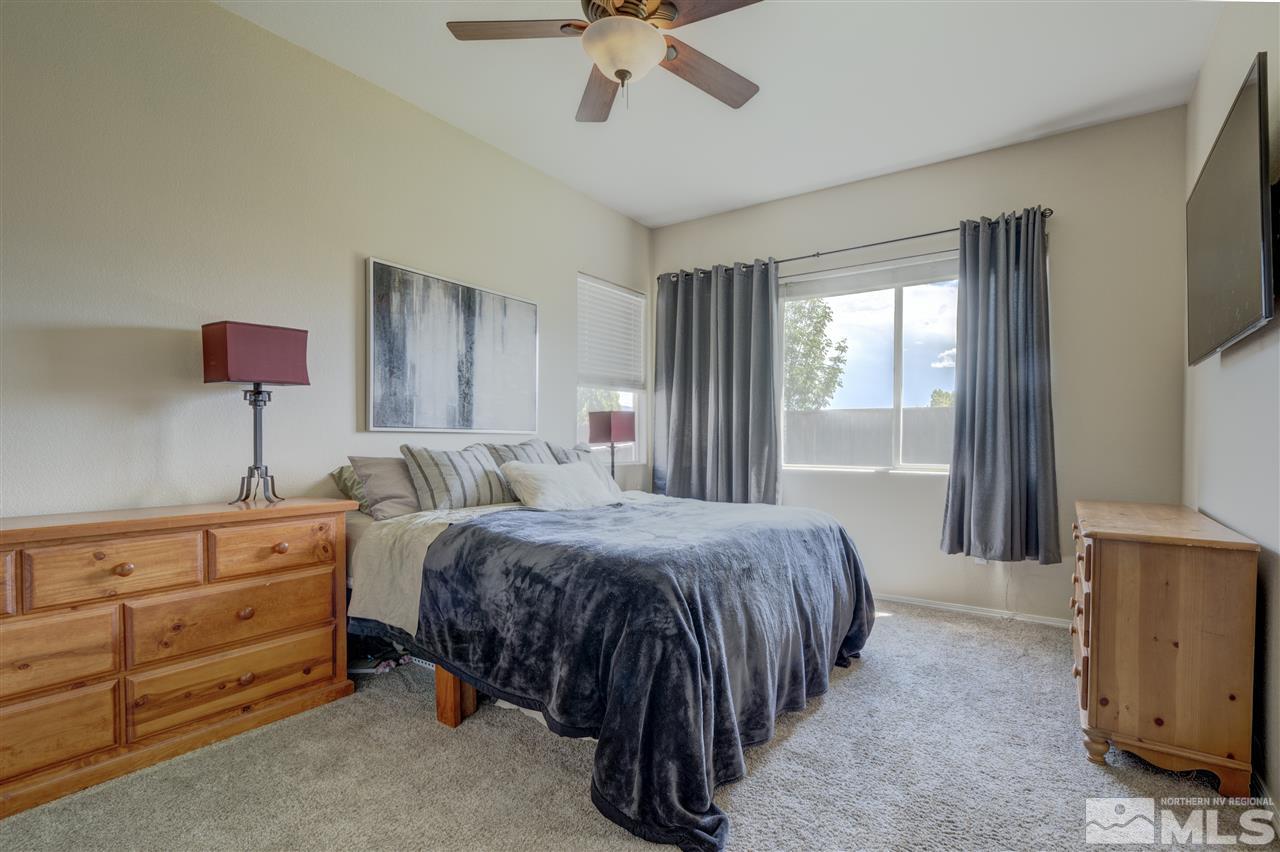 1660 Cattlemen Court Reno, NV 89521 - Photo 17 of 21 a bedroom with a bed and a chandelier