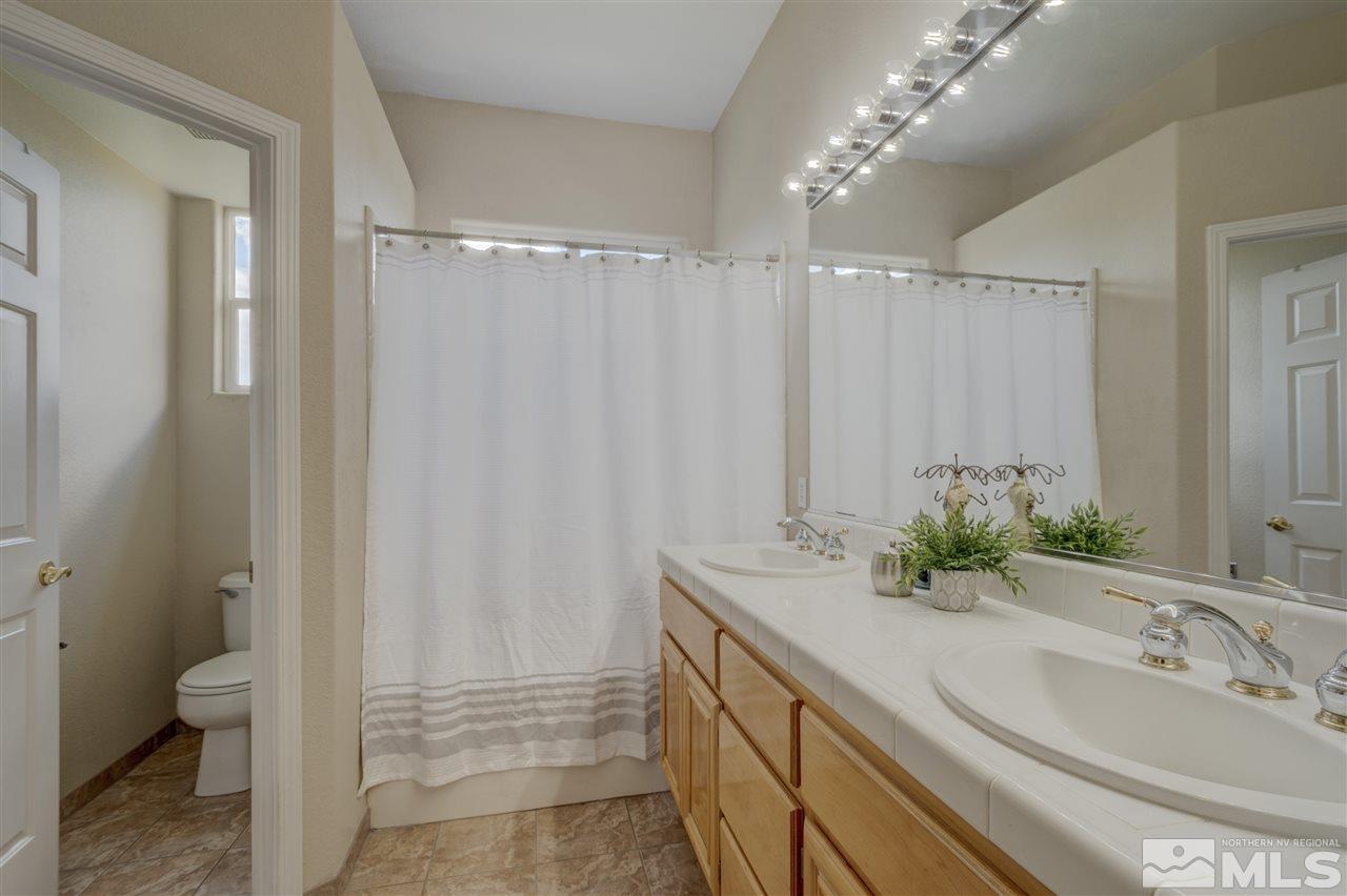 1660 Cattlemen Court Reno, NV 89521 - Photo 20 of 21 a bathroom with a double vanity sink and a mirror
