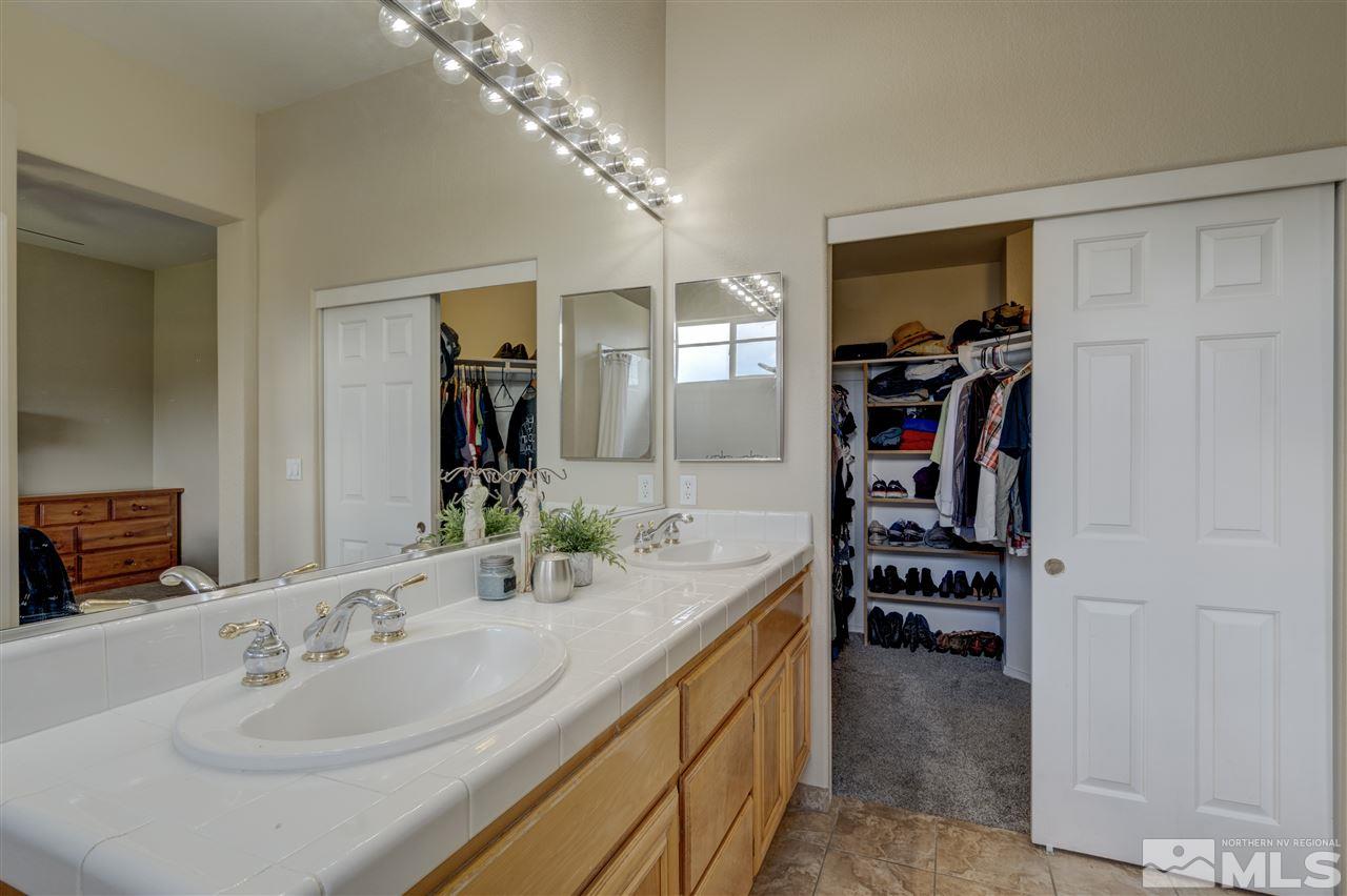 1660 Cattlemen Court Reno, NV 89521 - Photo 21 of 21 a en suite bathroom with a double vanity sink and a mirror