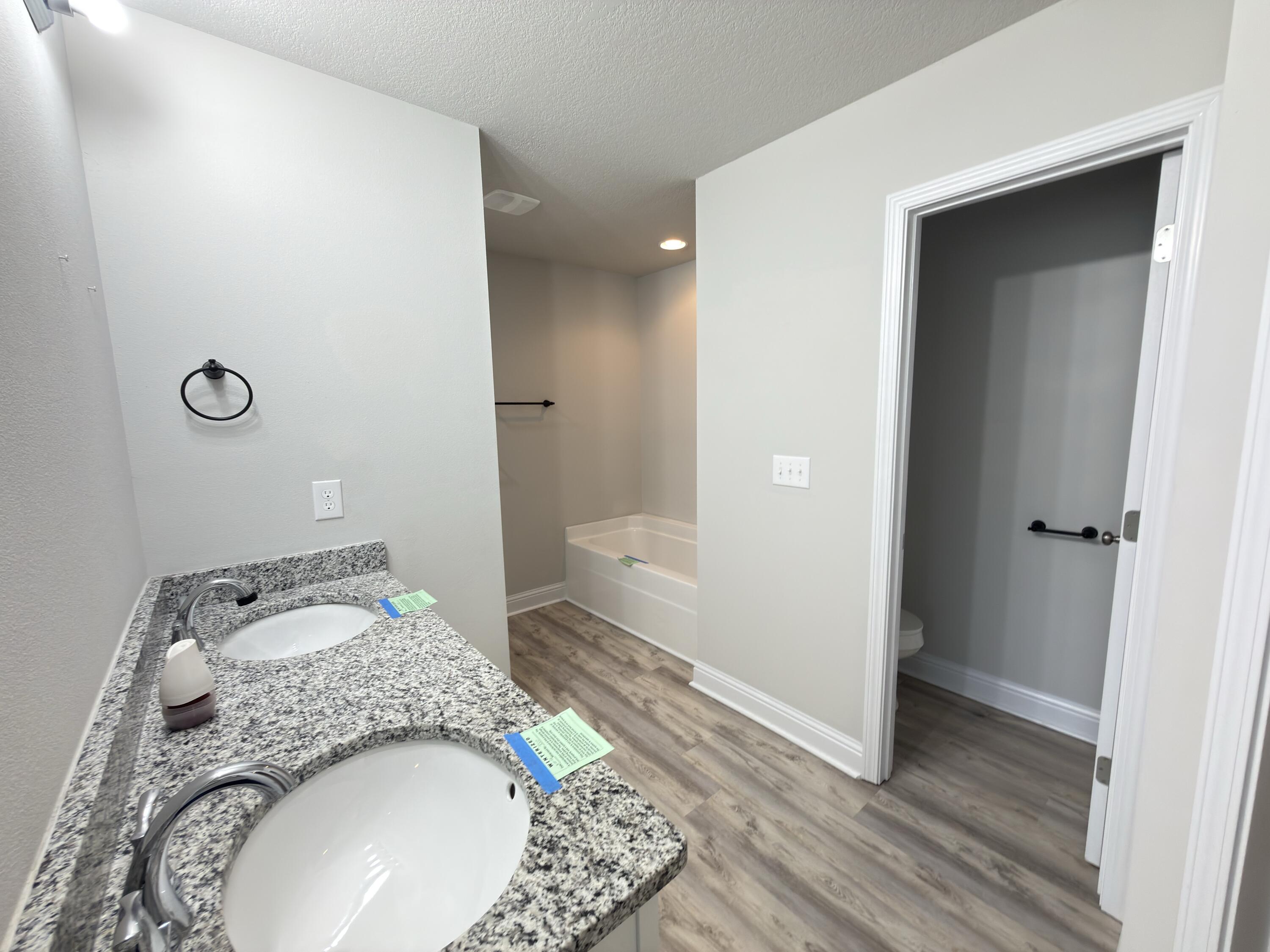 5281 Moore Loop Crestview, FL 32536 - Photo 19 of 28 a bathroom with a granite countertop sink and a mirror