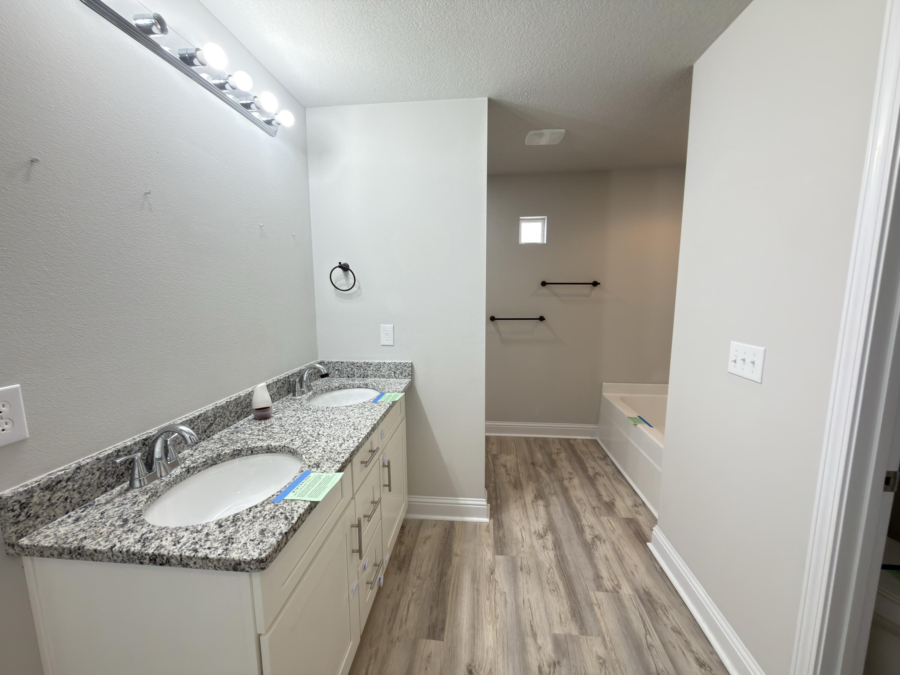 5281 Moore Loop Crestview, FL 32536 - Photo 20 of 28 a bathroom with a granite countertop sink a vanity and a mirror