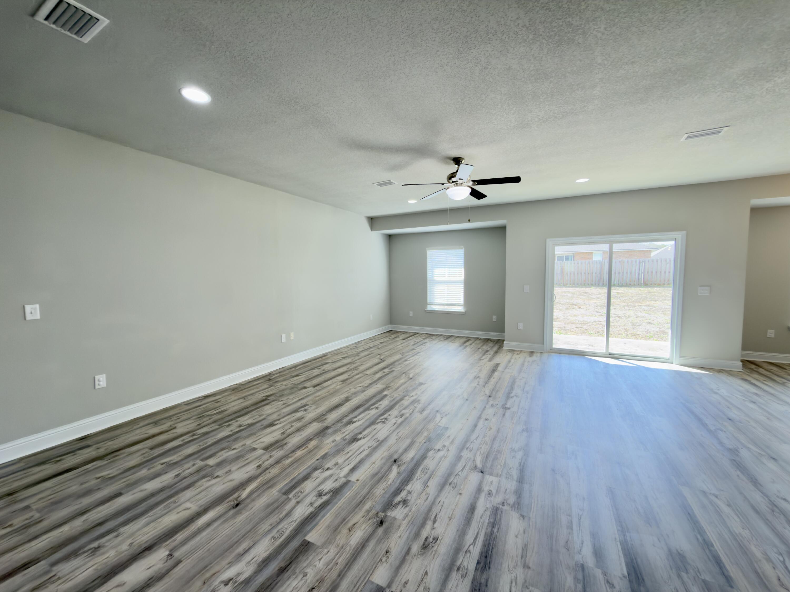 5281 Moore Loop Crestview, FL 32536 - Photo 2 of 28 a view of empty room with wooden floor and fan