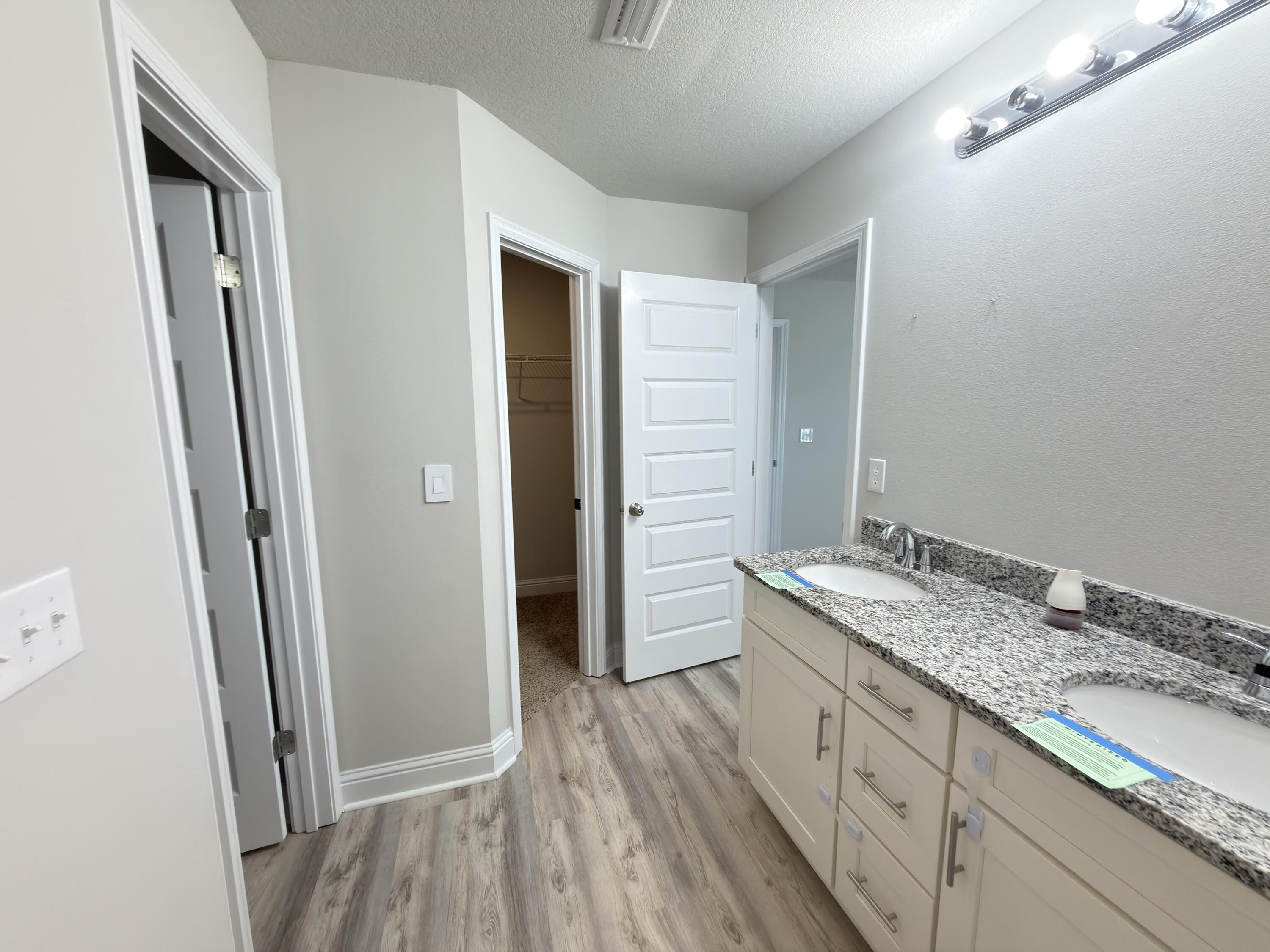 5281 Moore Loop Crestview, FL 32536 - Photo 21 of 28 a bathroom with a granite countertop sink toilet and shower