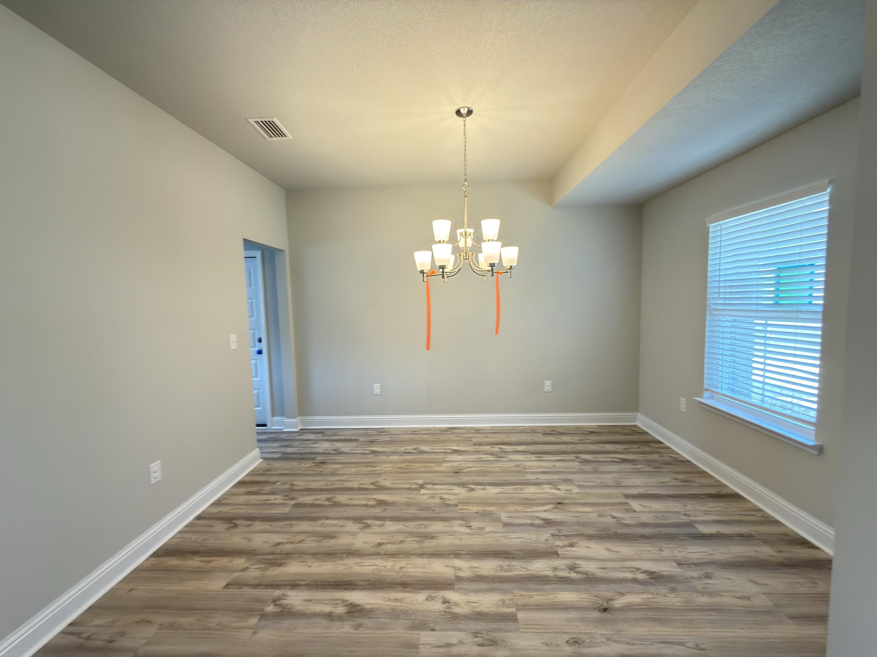 5281 Moore Loop Crestview, FL 32536 - Photo 23 of 28 a view of a room with a chandelier fan and windows